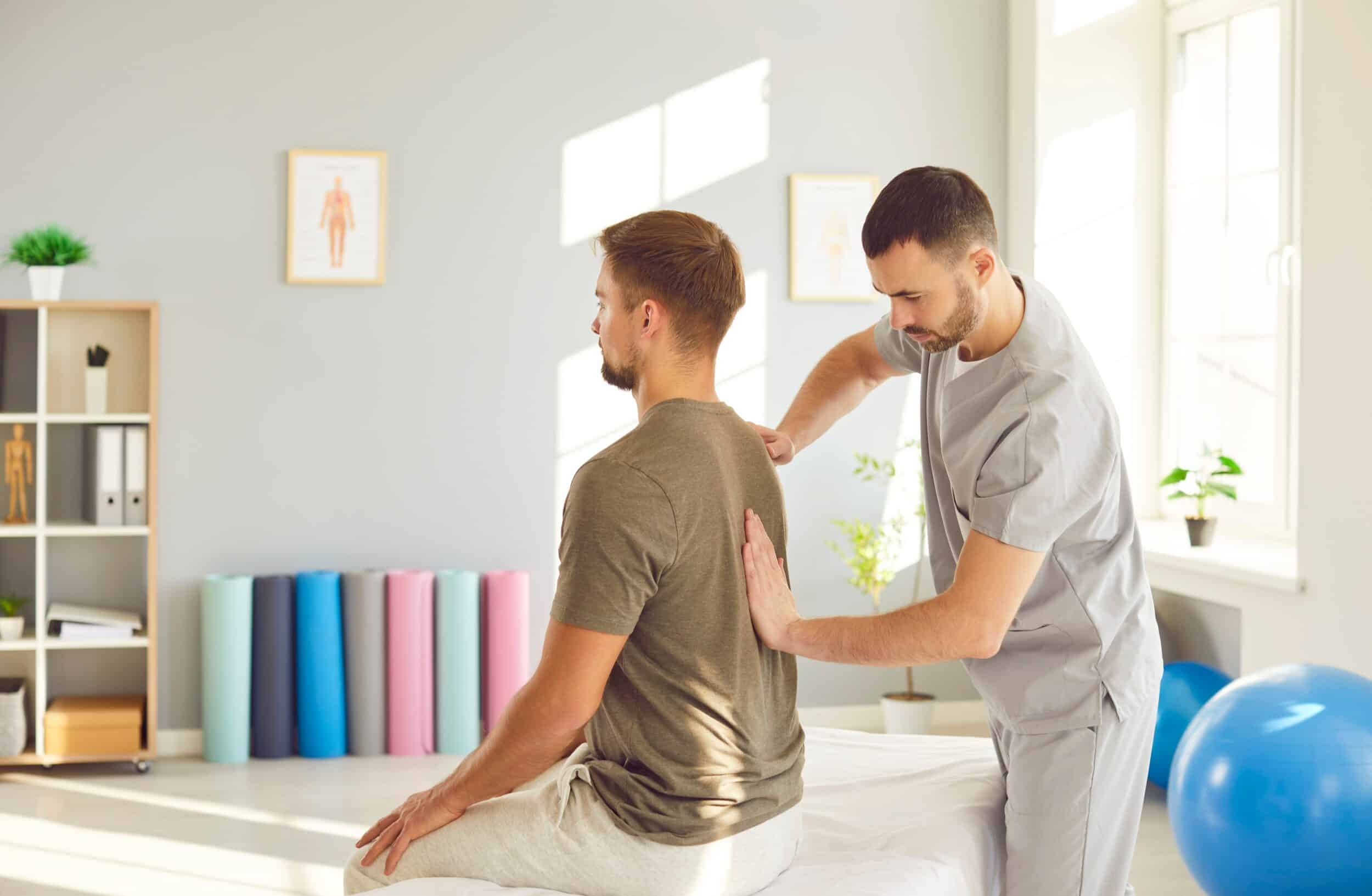 Professional therapist performing spinal rehabilitation and manual back therapy to treat injury and trauma under orthopedic care